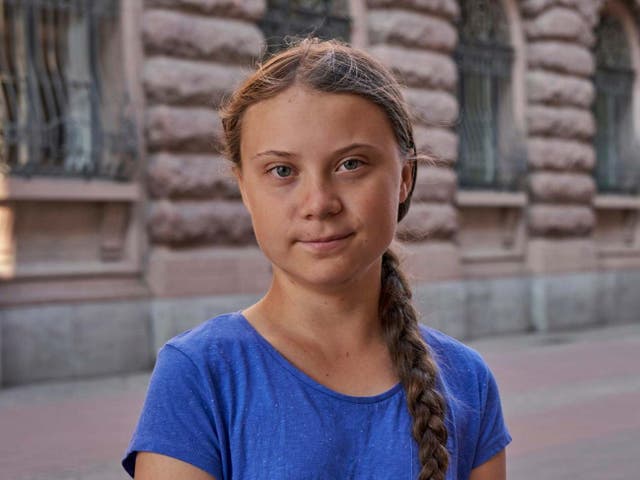 Greta Thunberg stands next to Swedish parliament in Stockholm