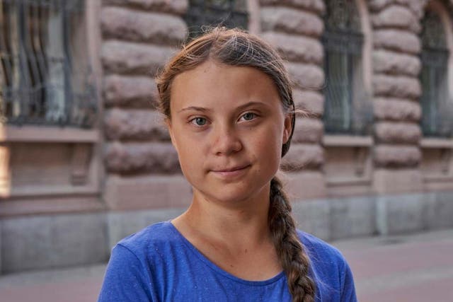 Greta Thunberg stands next to Swedish parliament in Stockholm