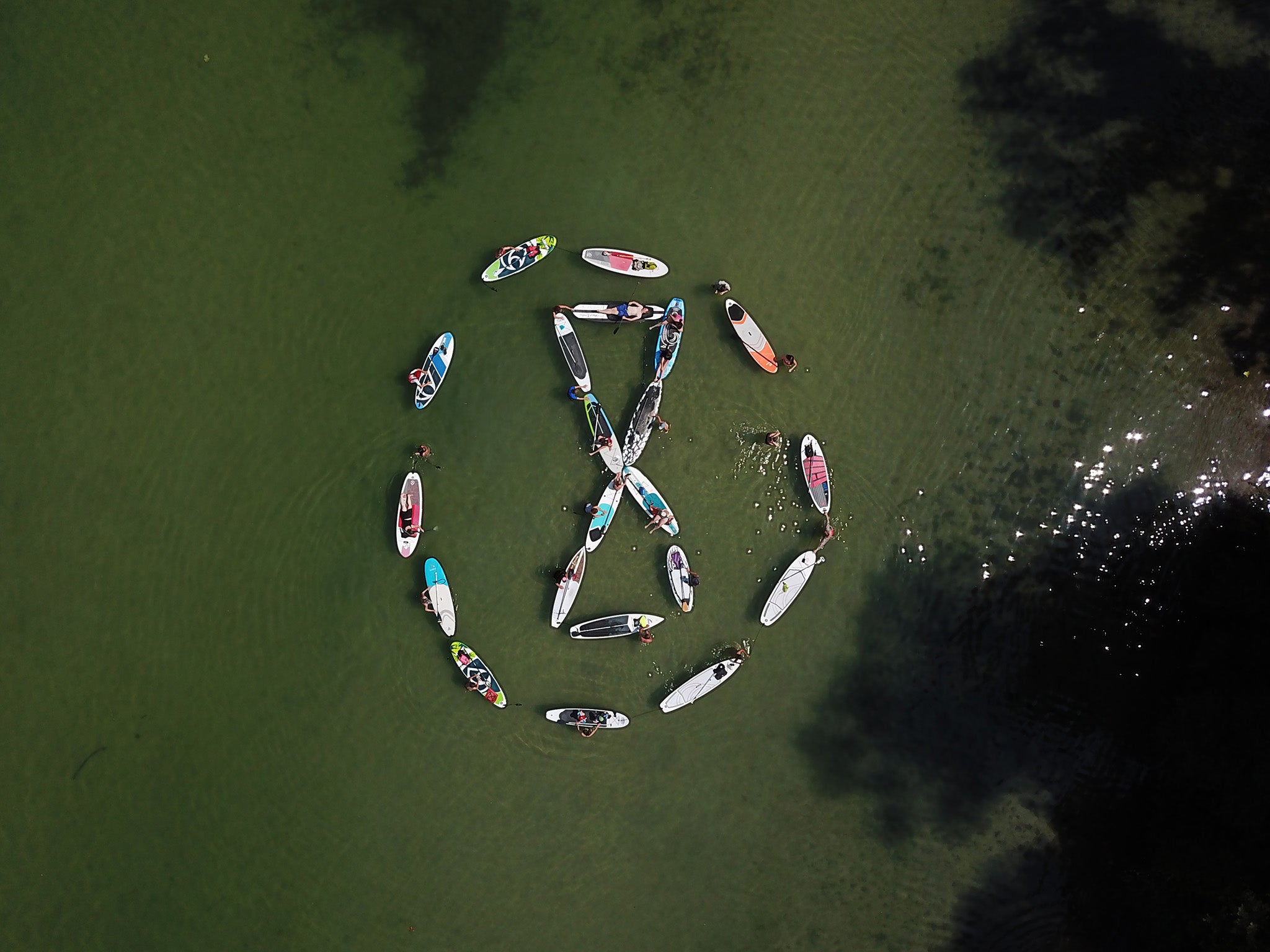 A group of paddle boats form the XR logo on Lake Morat, Switzerland