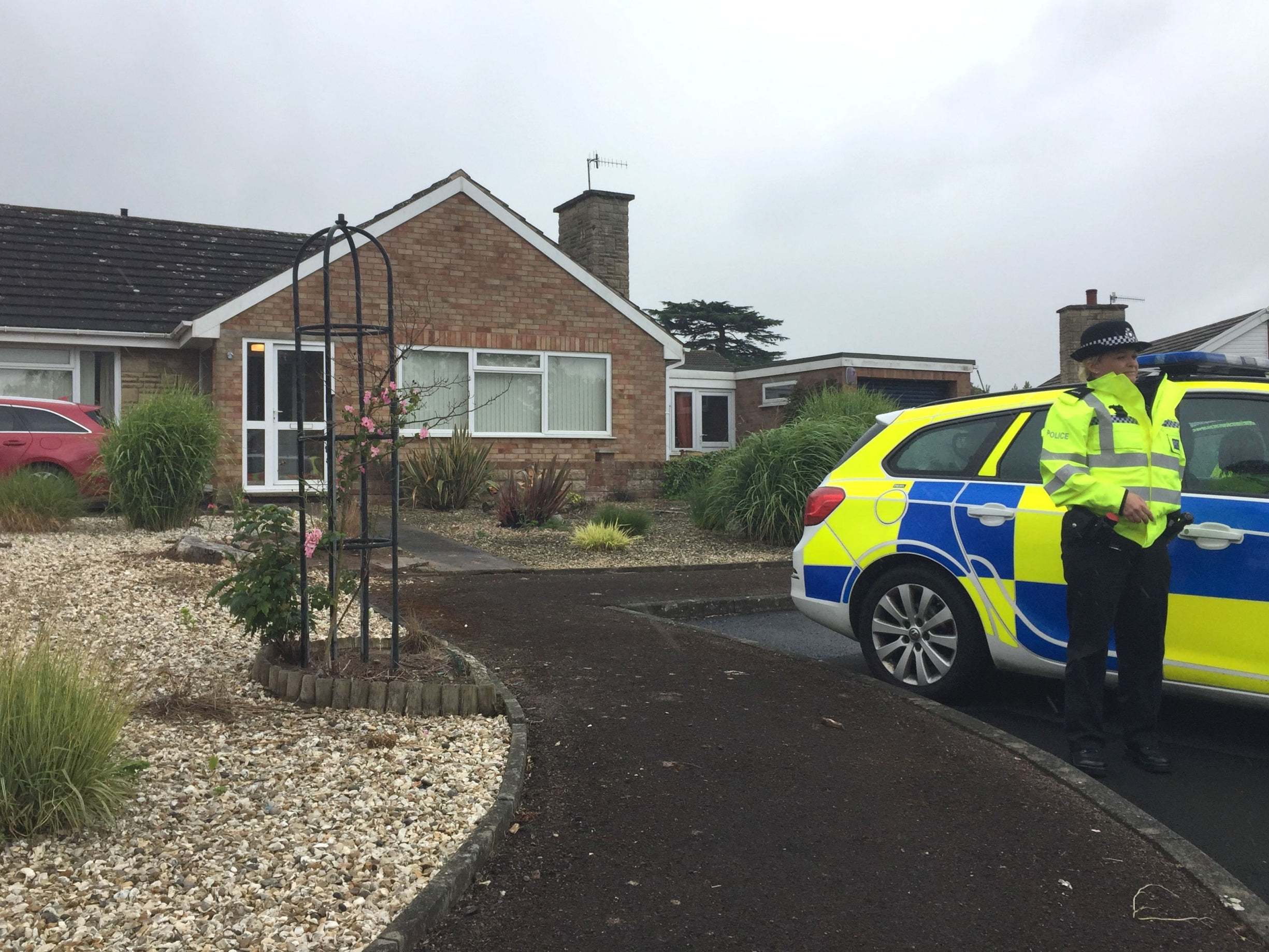 West Mercia Police officers outside a bungalow in Kempsey after female human remains were found in the village