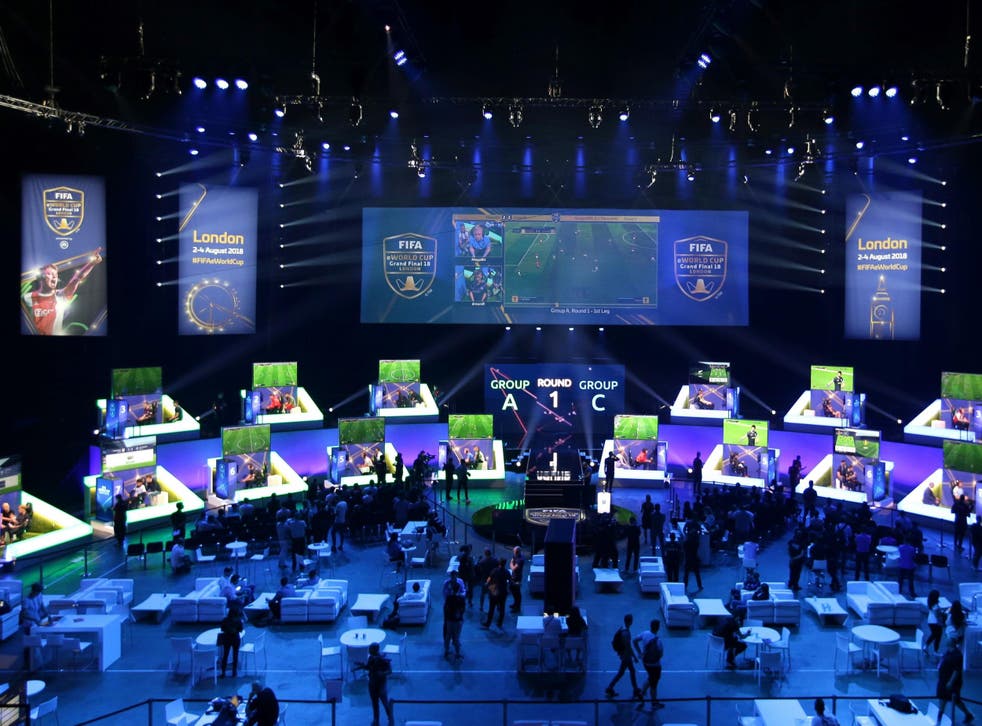 Players compete on Xbox and Playstation games consoles in the group stages of the FIFA eWorld Cup Grand Final in London on 2 August 2, 2018