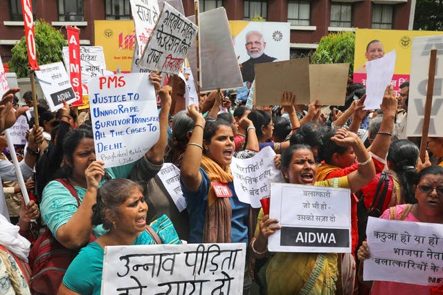 Activists in Delhi shout slogans during a protest demanding a fast-track probe into a highway accident that critically injured a woman who has accused a ruling BJP politician of rape