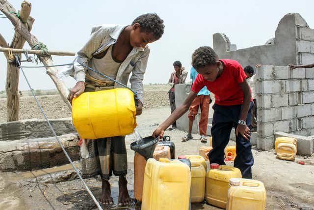 A displaced Yemeni boy collects water from the Red Sea port city of Hodeida