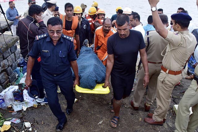 National Disaster Response Force (NDRF) personnel carry the body of missing Indian coffee tycoon V G Siddhartha from the banks of the Netravati river towards a waiting ambulance on Wednesday