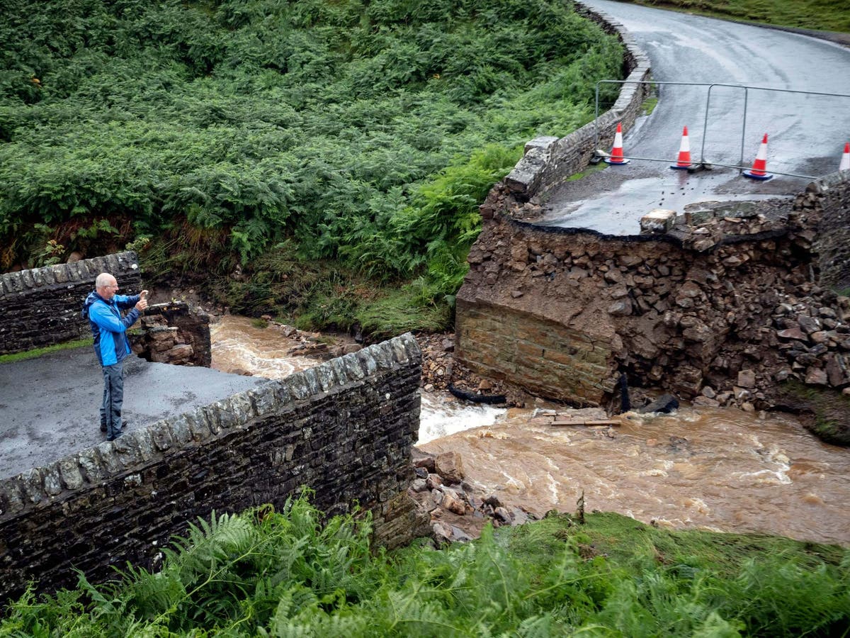 UK weather Army called in after flash floods wash away bridges and