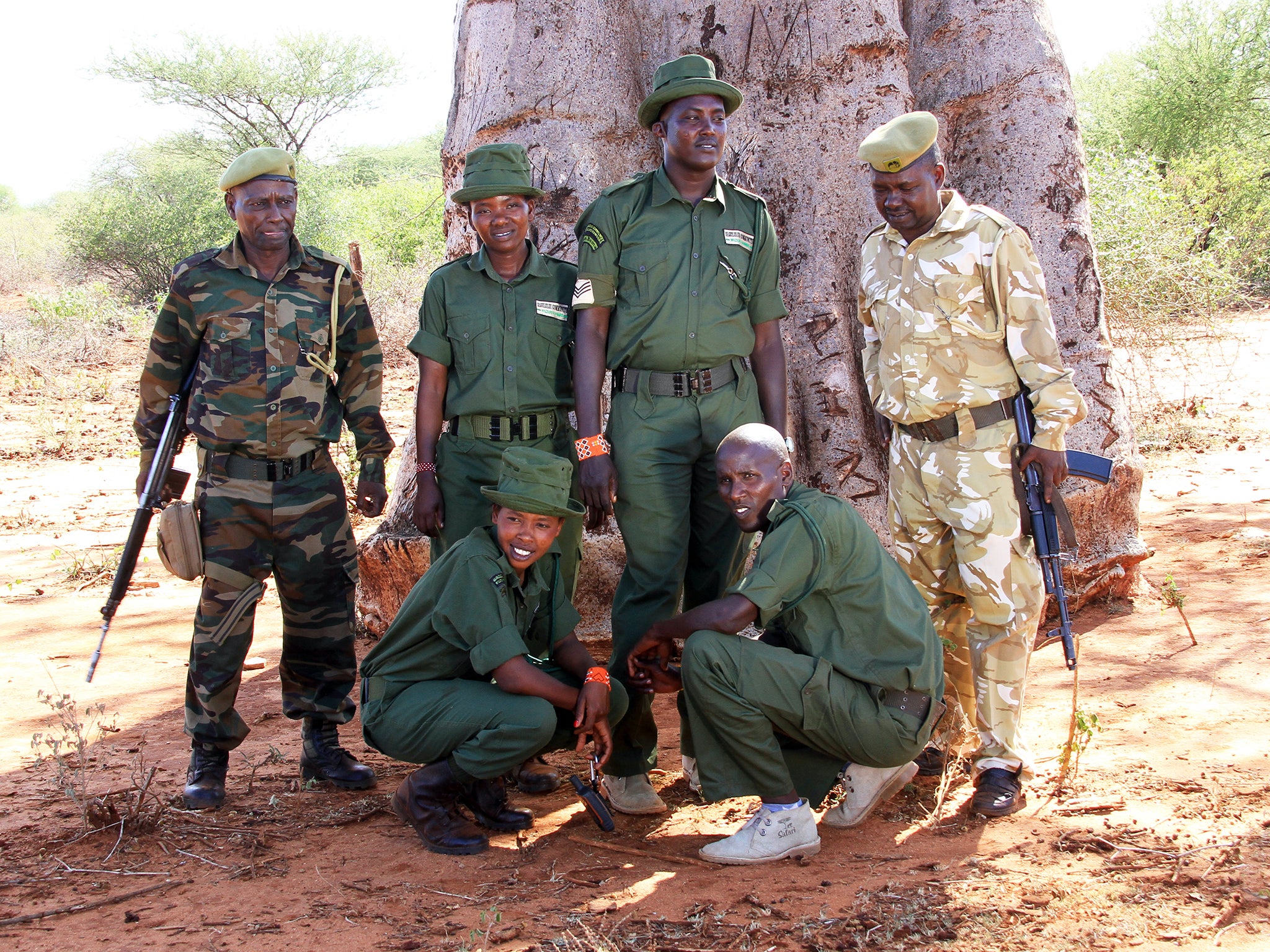 The community rangers team, in dark green, work together with the KWS rangers, in camouflage, on foot patrols around the park