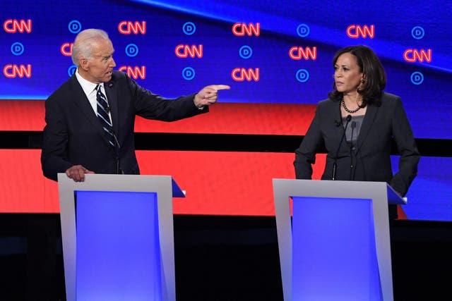 Democratic presidential hopeful Former Vice President Joe Biden gestures toward US Senator from California Kamala Harris