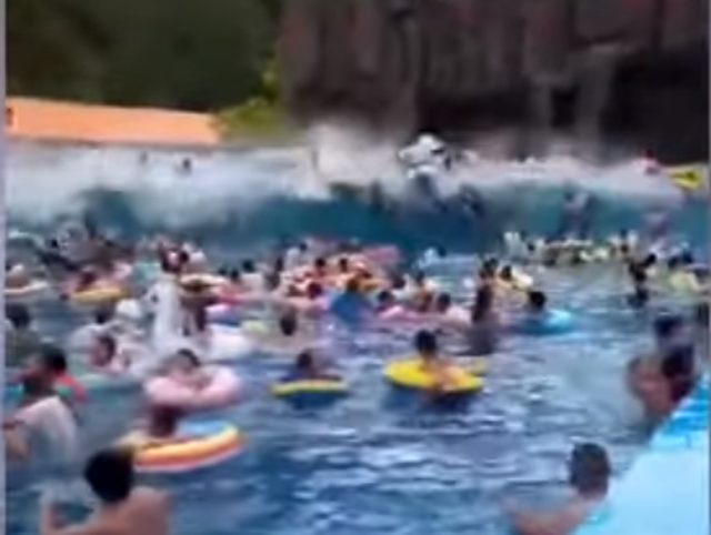 Dozens of unsuspecting swimmers are hurled through the air as the artifical tsunami crashes through the waterpark