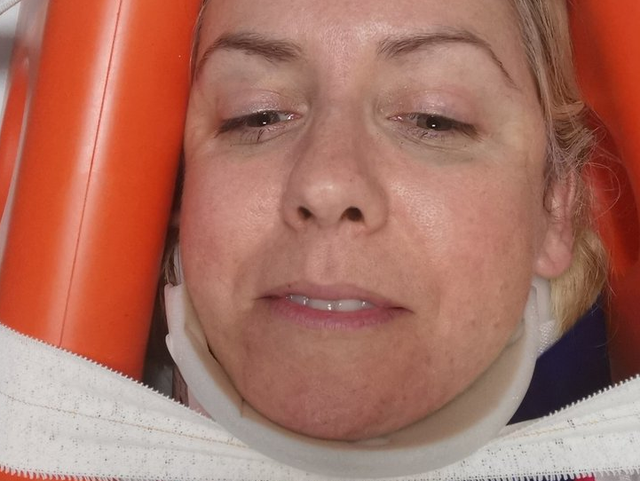 Andrea Jenkyns in a neck and head brace after falling off her chair