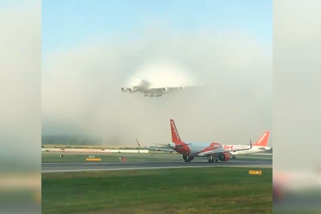 Watch this Emirates A380 burst through fog at Gatwick airport