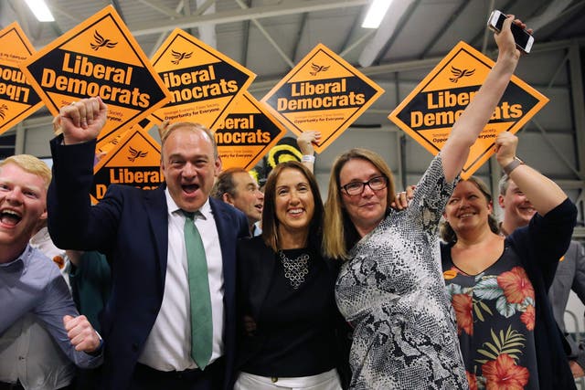 Liberal Democrat candidate Jane Dodd (C) celebrates with MP Ed Davey (L) and and her team after winning the Brecon and Radnorshire by-election