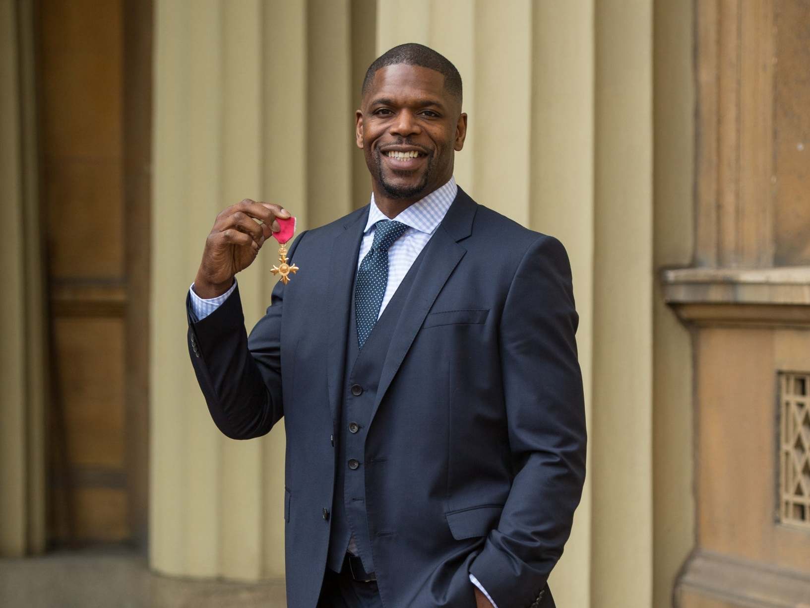 Prince poses after being appointed OBE for services to tackling knife and gang crime