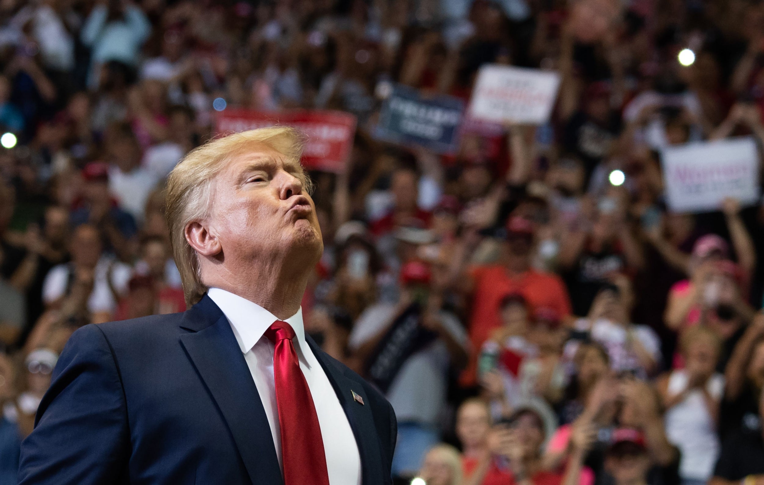 Donald Trump gestures as he arrives at his campaign rally