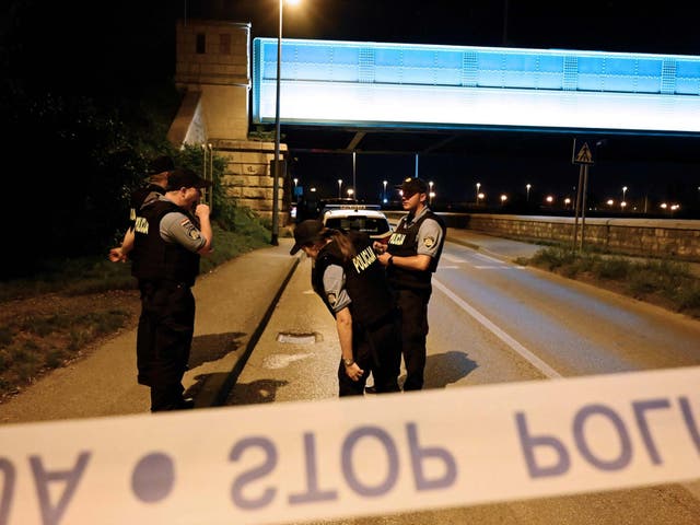 Police officers stand guard at a check point near the place where six people were shoot dead in Zagreb on August 1, 2019