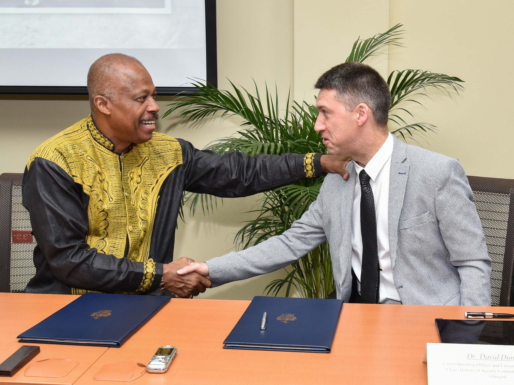 Reparations agreement: Professor Sir Hilary Beckles of the University of the West Indies, left, shakes hands with Dr David Duncan of the University of Glasgow