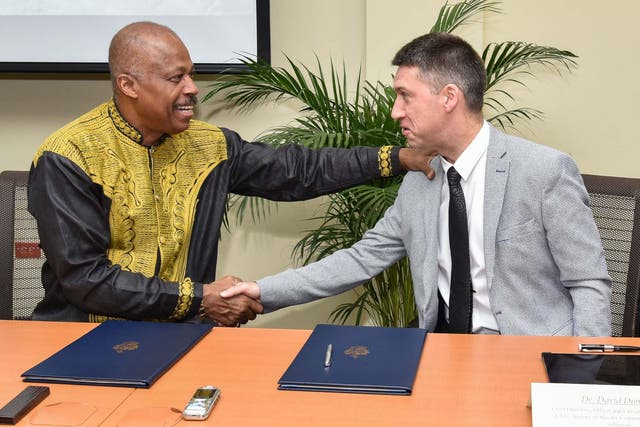 Reparations agreement: Professor Sir Hilary Beckles of the University of the West Indies, left, shakes hands with Dr David Duncan of the University of Glasgow
