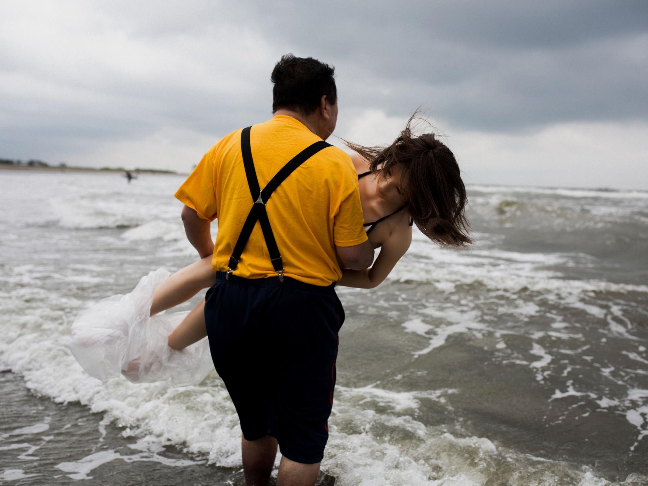 Many of South Korea's life-size sex dolls come from Japan, where a man is seen going surfing with his £5,000 doll