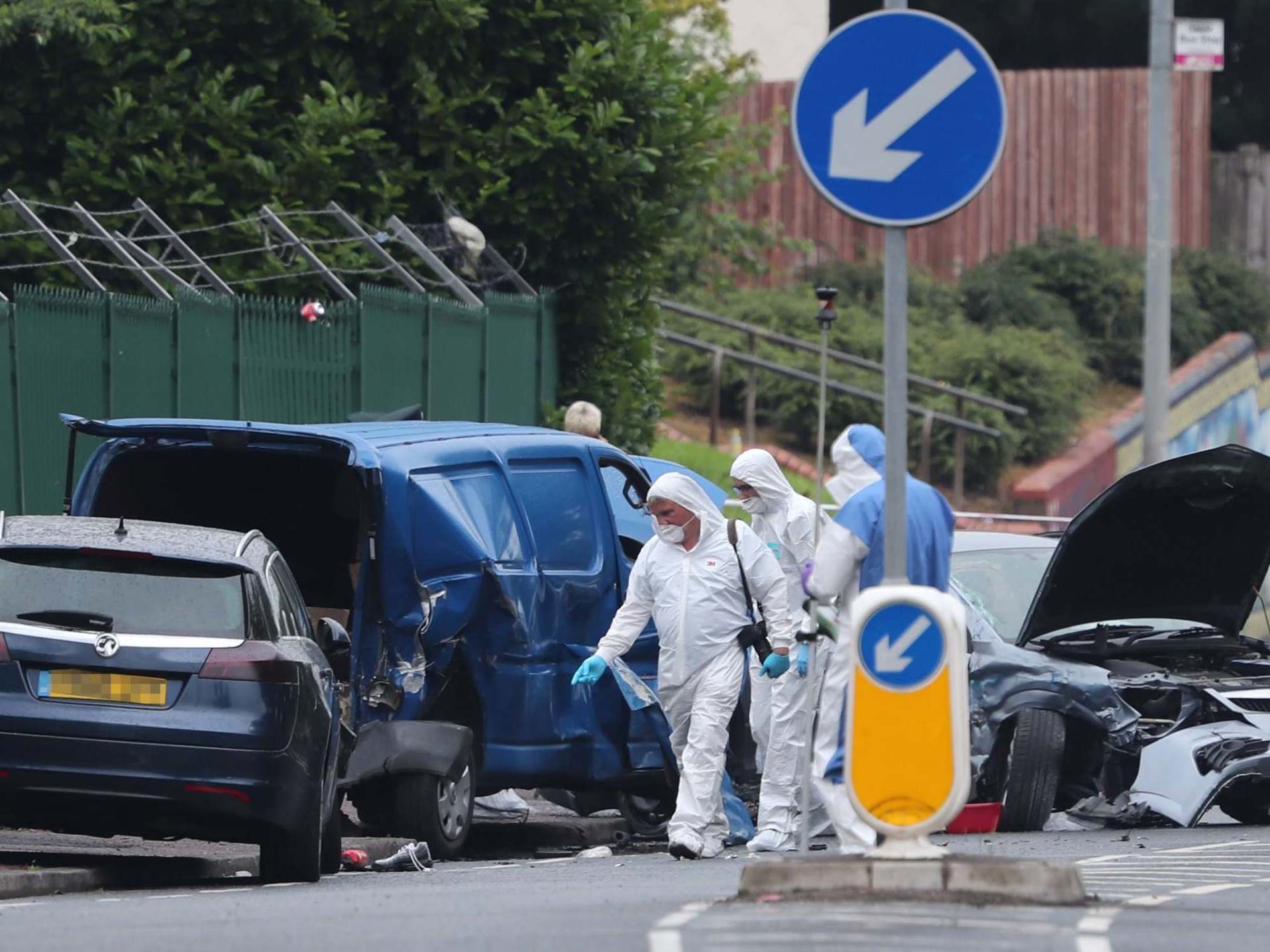Forensics officers outside Belfast city cemetery were a car hit pedestrians