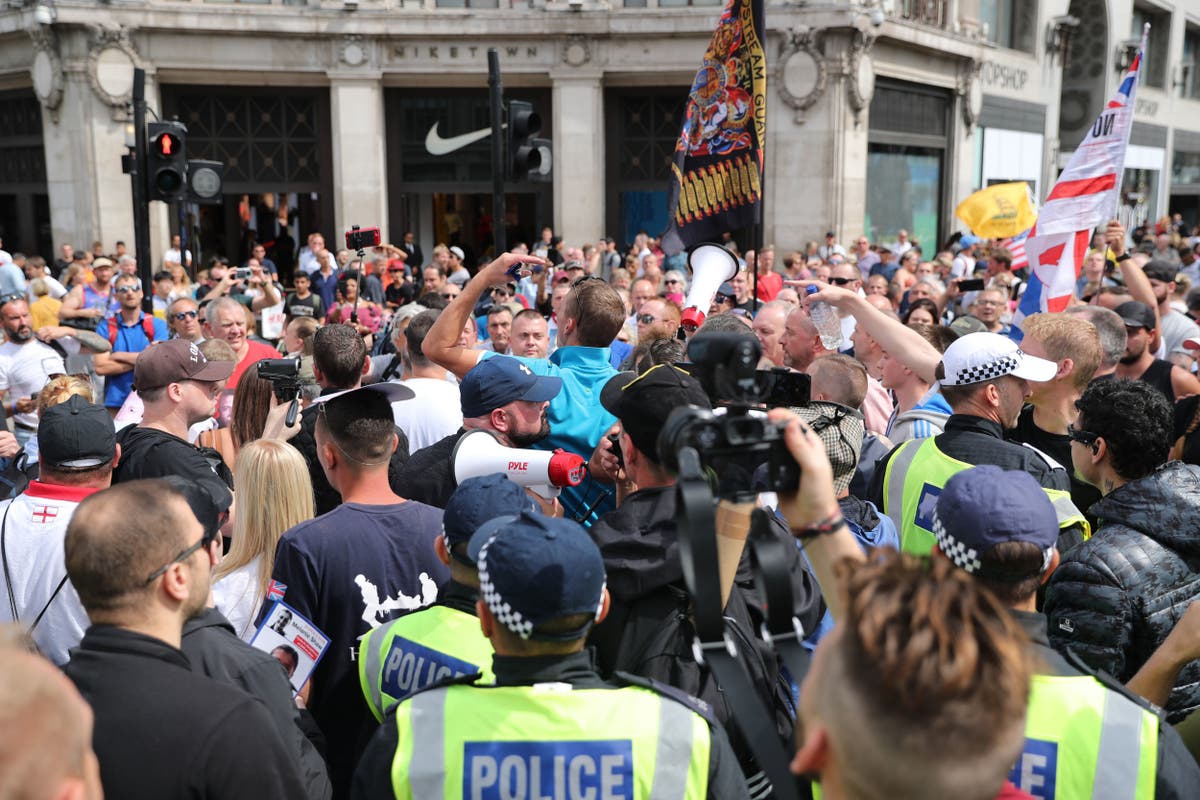 Tommy Robinson Police hunting two protesters after medic dragged to