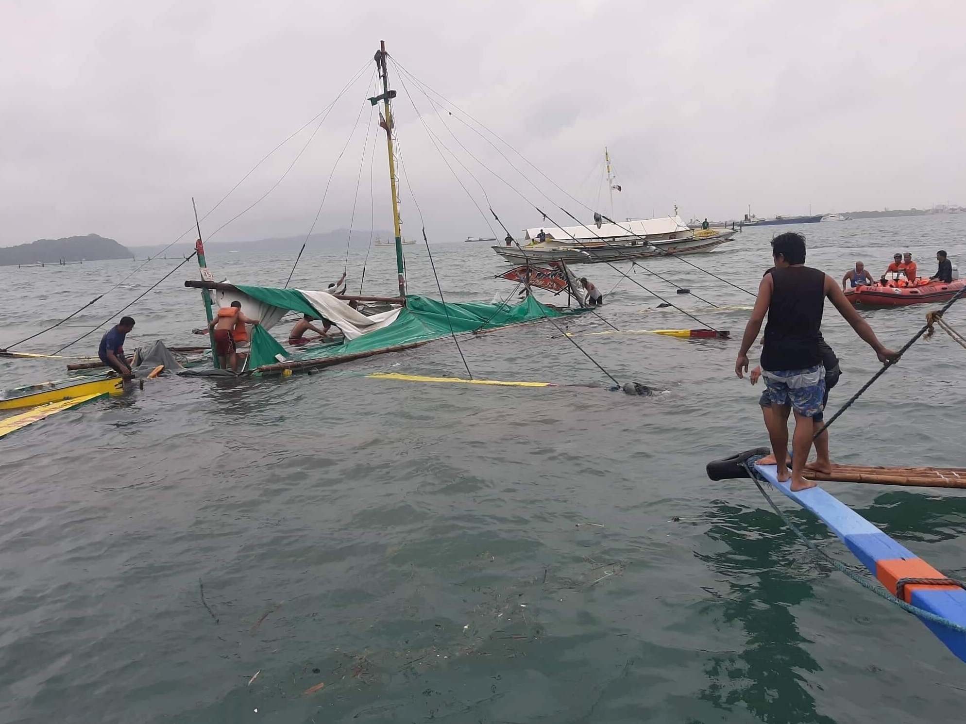 Three boats capsized after being flipped over by sudden wind gusts and powerful waves off two central Philippine provinces