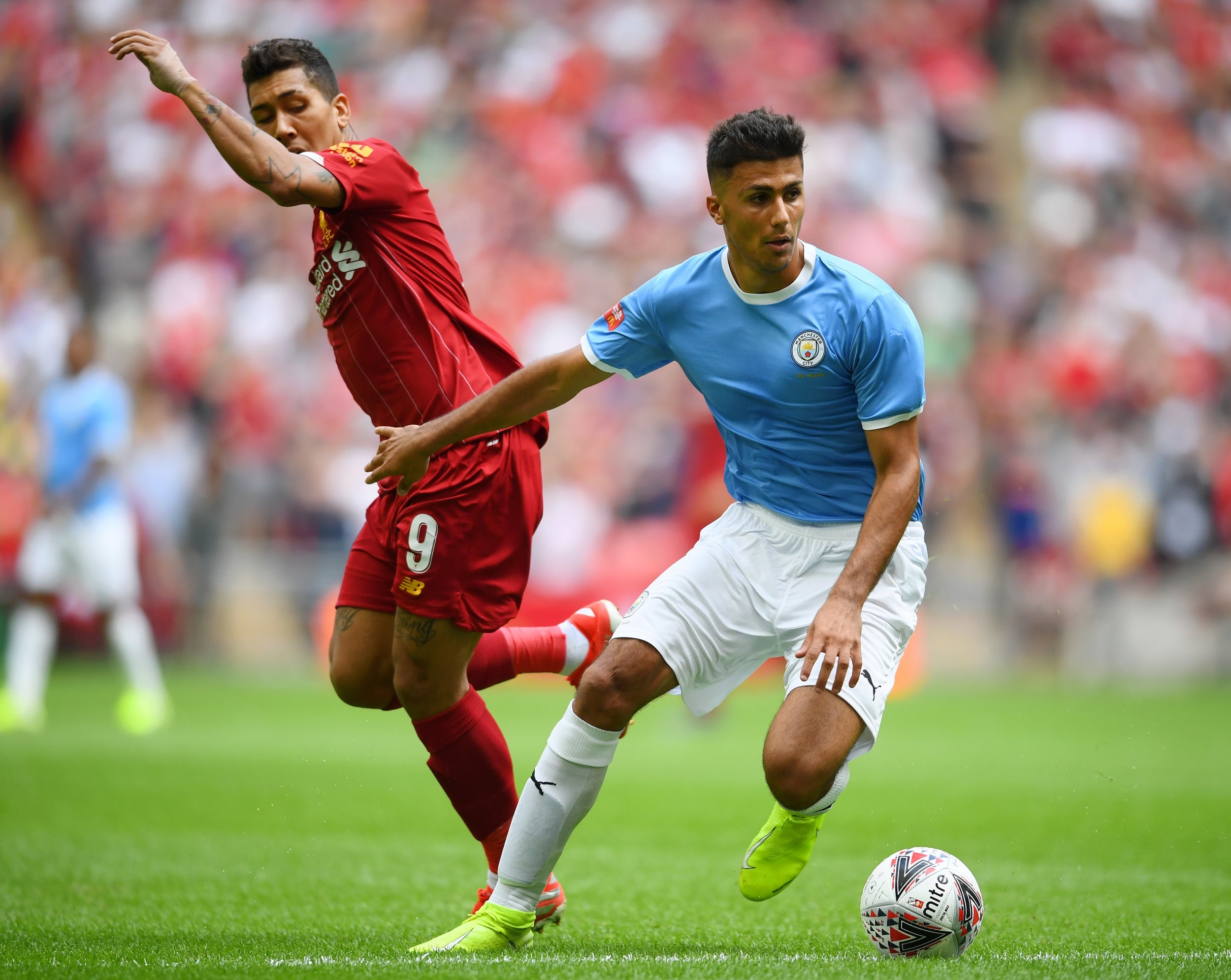 Rodri shields the ball from Firmino