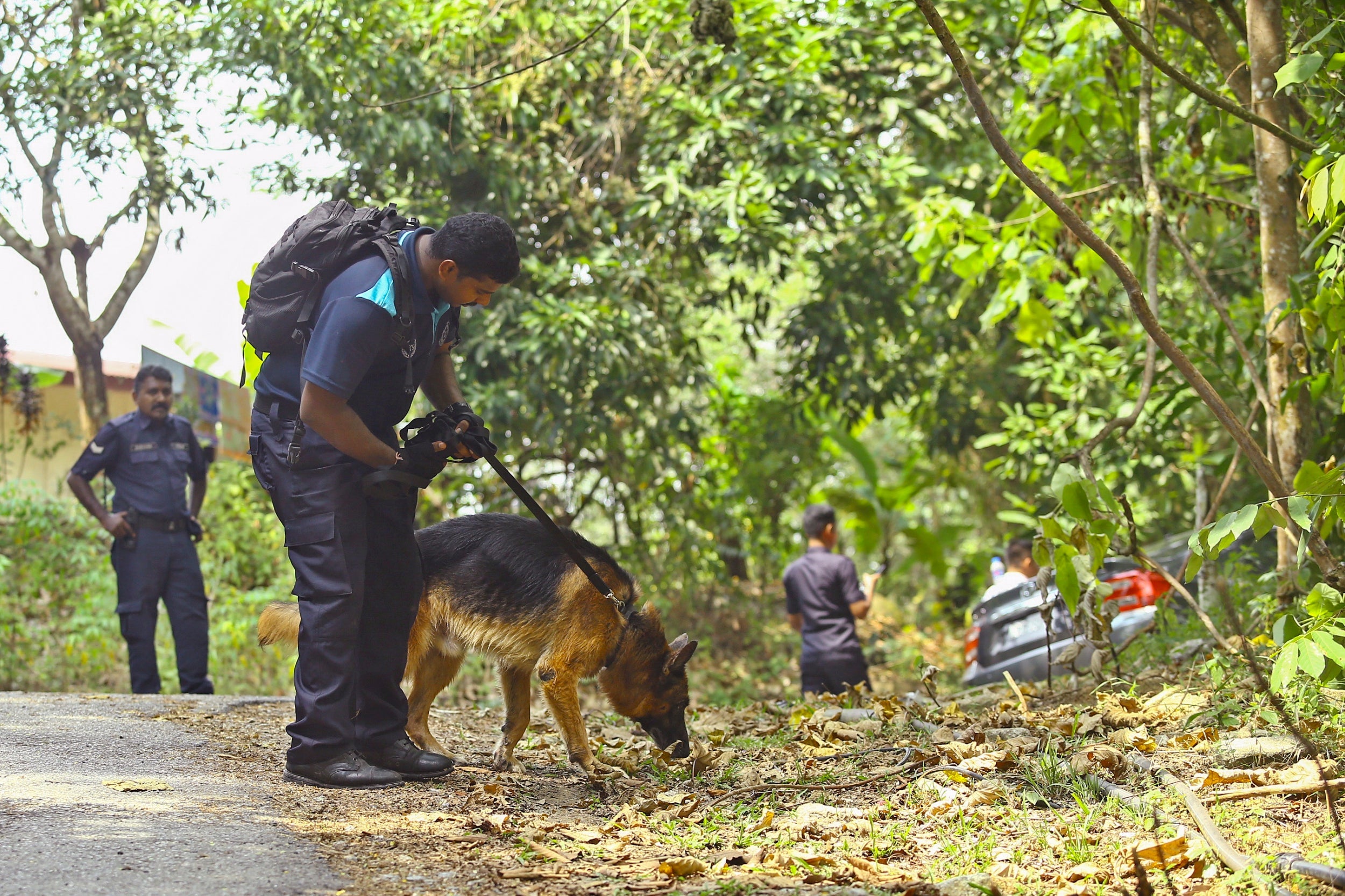 A Malaysian police officer and his dog takes part in the search for missing 15-year-old Nora Quoirin from London