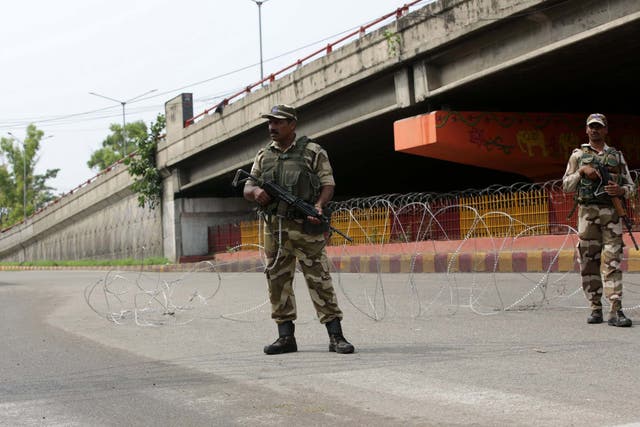 Indian soldiers stand guard during a curfew in the Kashmiri city of Jammu