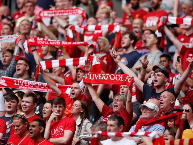 Liverpool fans hold up their scarfs