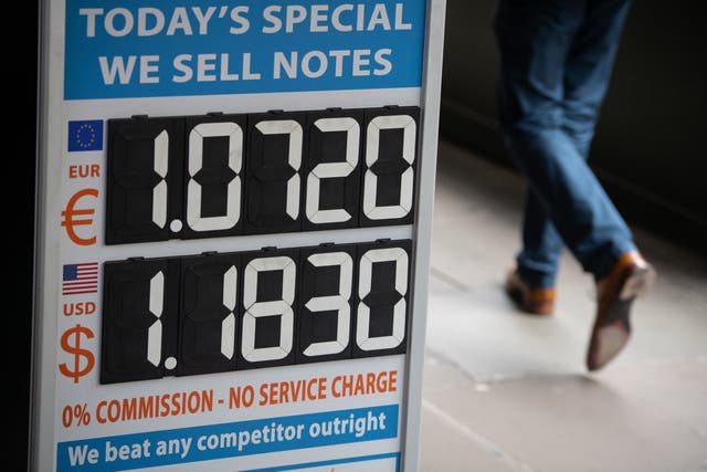 Foreign exchange rates are displayed at a currency exchange in central London