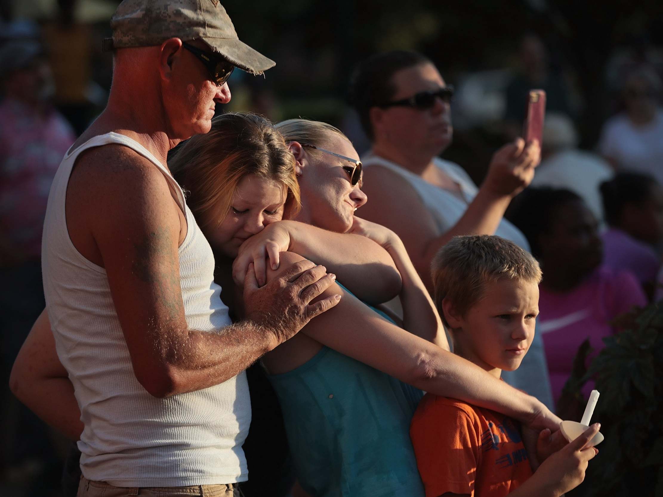 Tearful families gather at the scene of a mass shooting in Dayton, Ohio, which killed nine