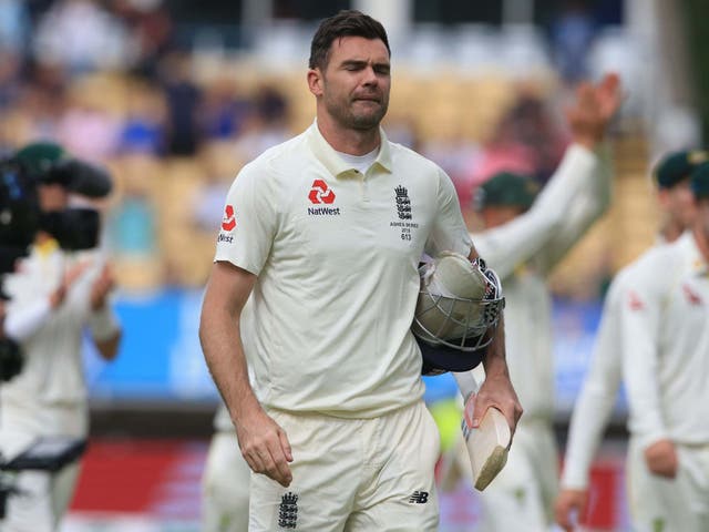 England's James Anderson walks from the field