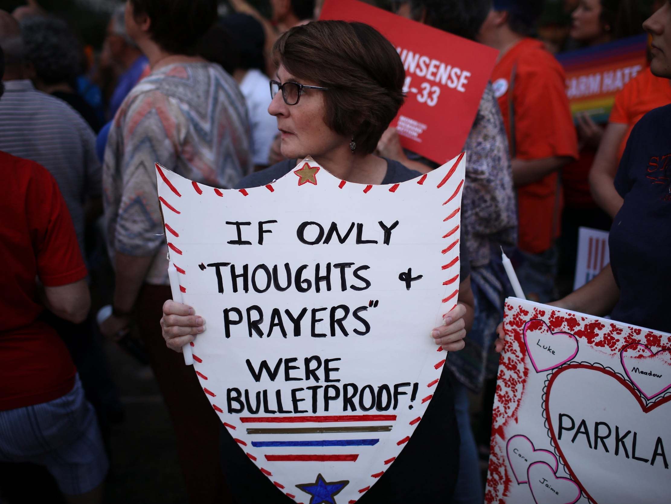 Advocates of gun reform legislation hold a candle light vigil for victims of recent mass shootings outside NRA headquarters on 5 August 2019