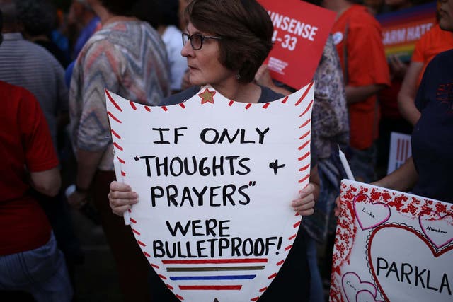 Advocates of gun reform legislation hold a candle light vigil for victims of recent mass shootings outside NRA headquarters on 5 August 2019