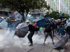China warns Hong Kong protesters as police amass near border