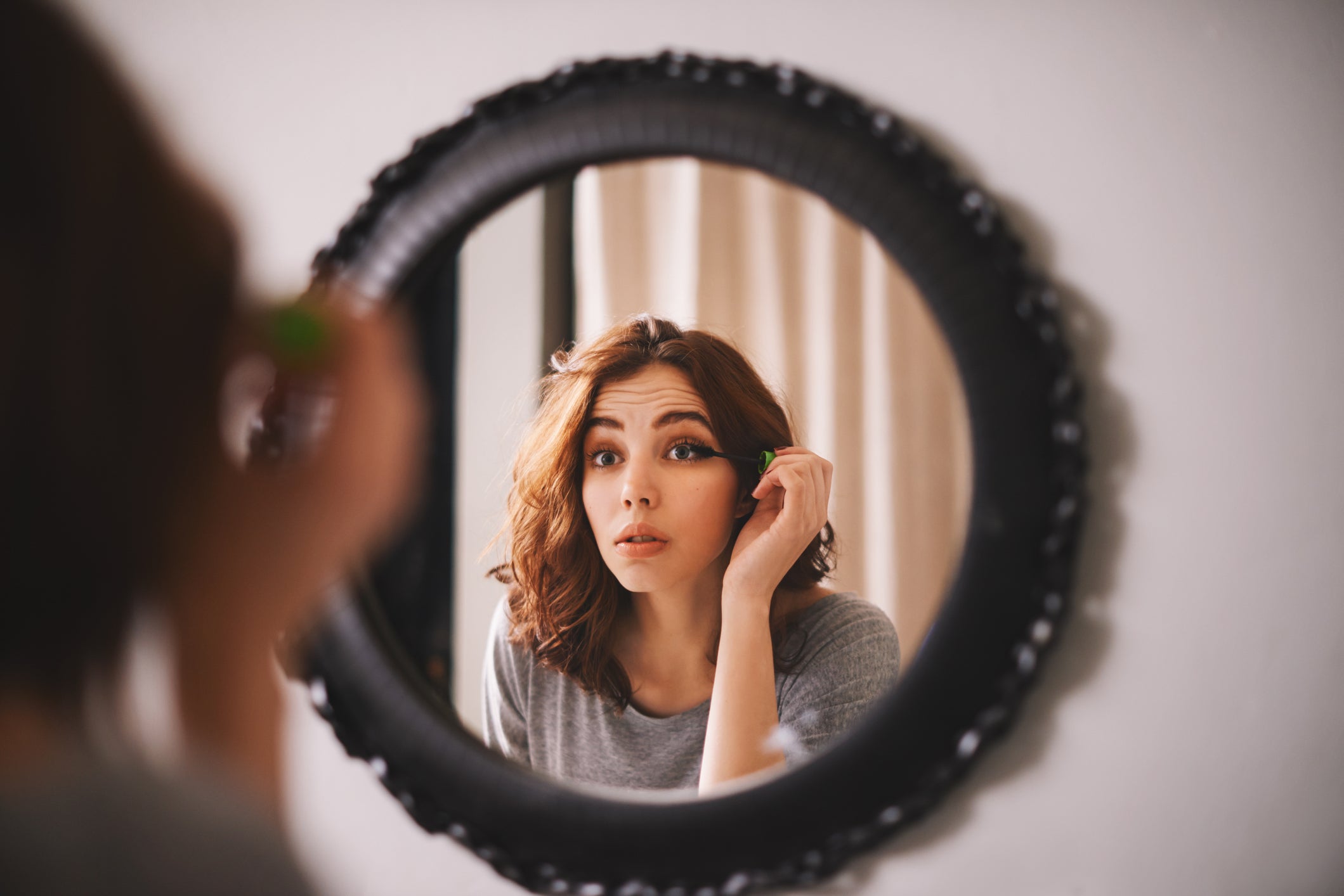 Woman applying mascara