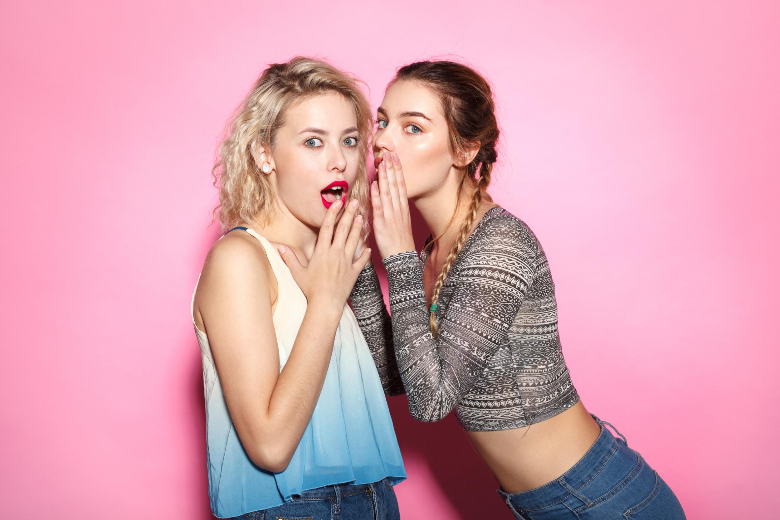 Two young girl gossiping