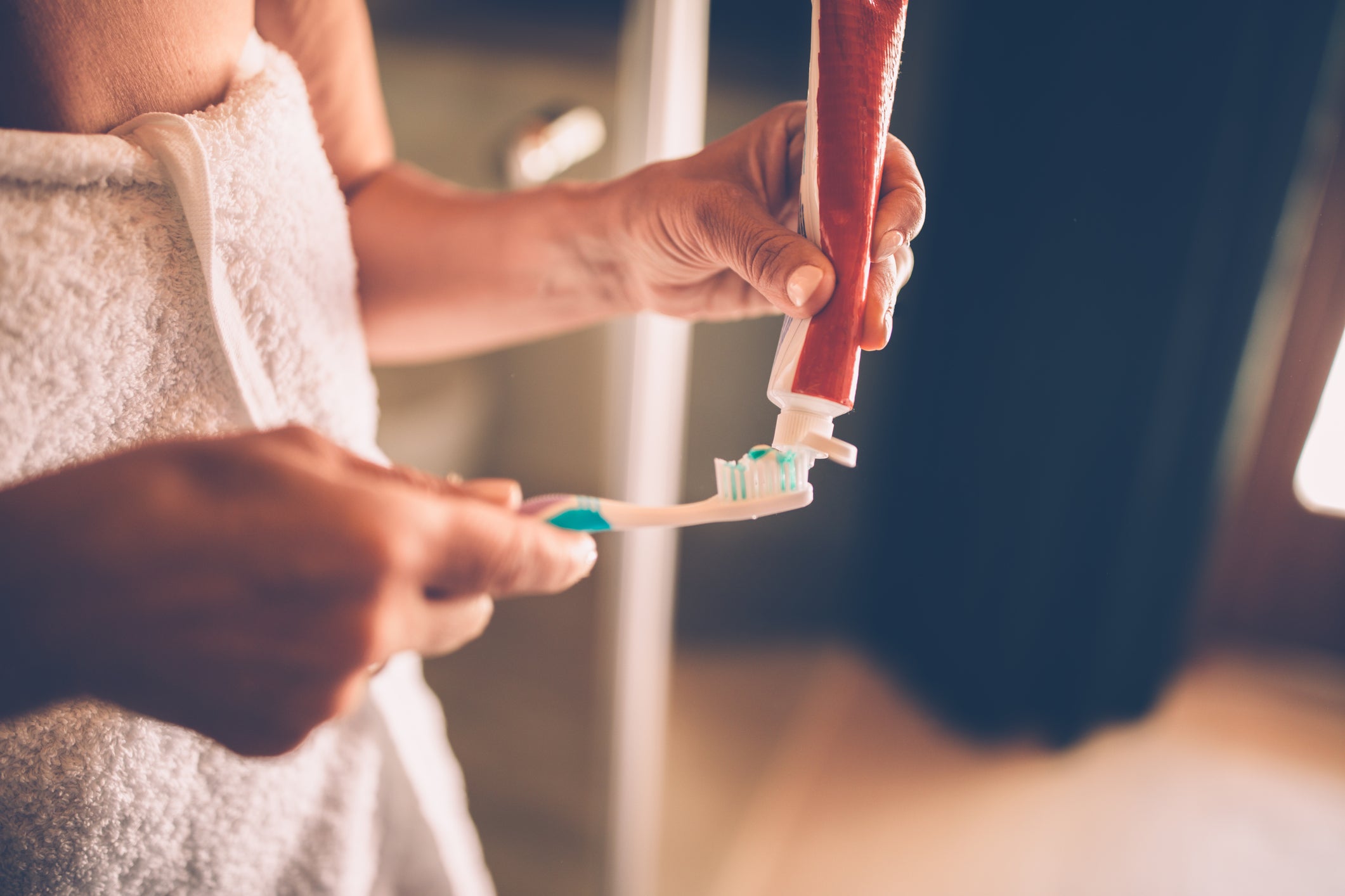 Close-up of mature woman getting ready to brush her teeth