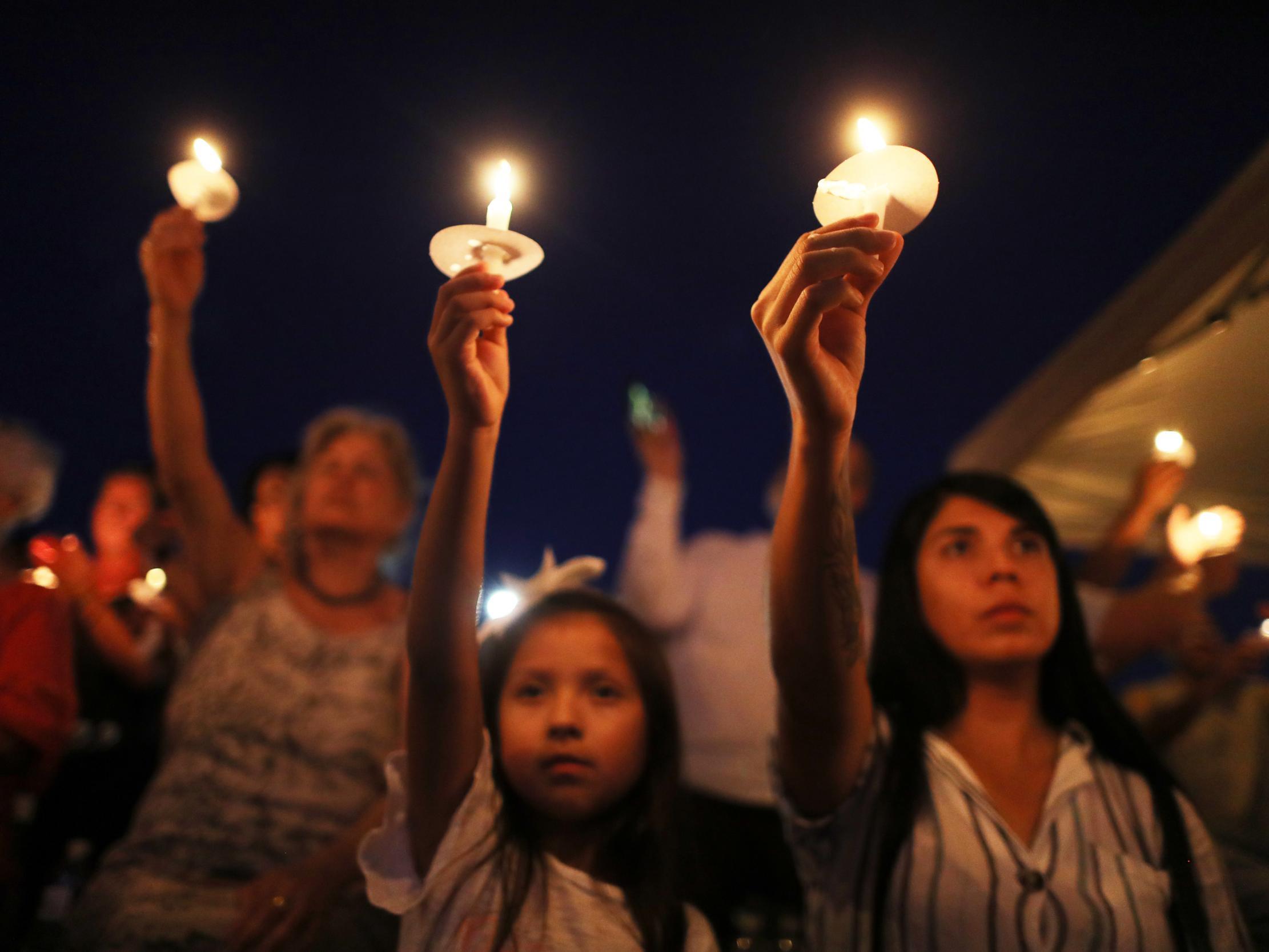 Mourners hold a candlelit vigil near the scene of a mass shooting that saw 22 people, eight of them Mexican, in the Southern border city of El Paso