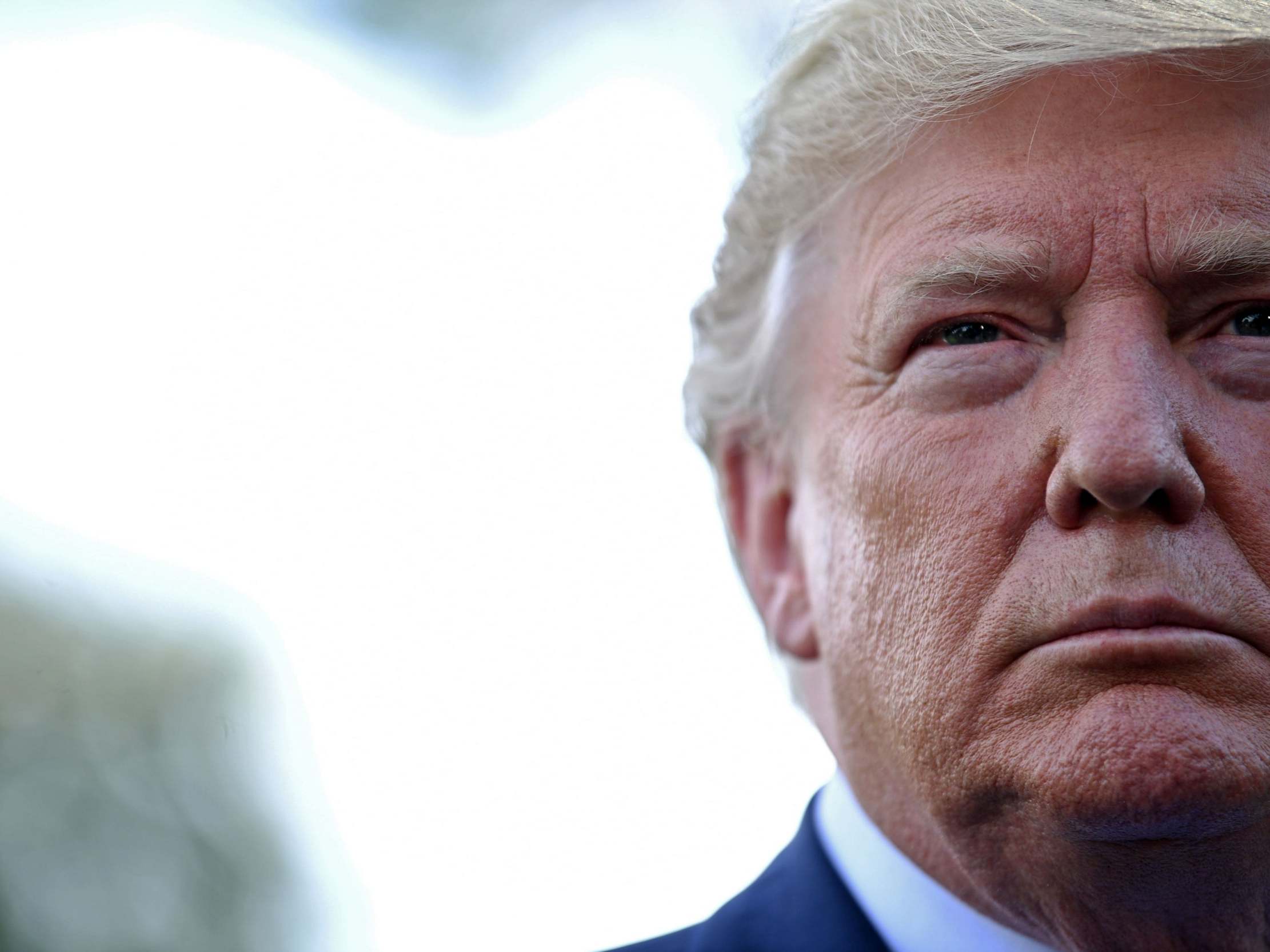 Donald Trump speaks to the press at the White House as he departs for Bedminster