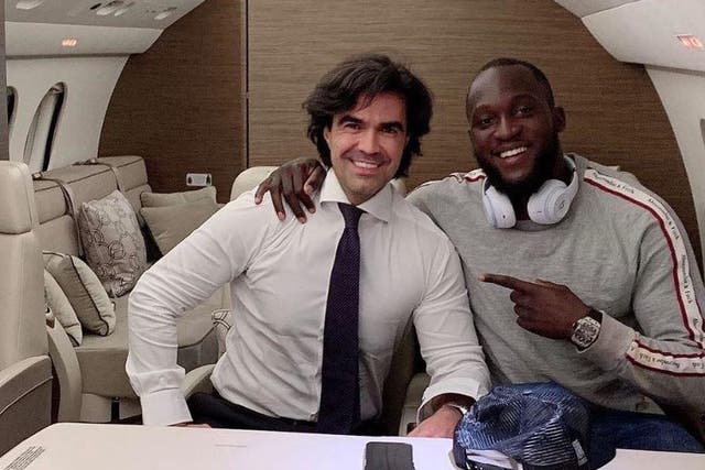 Romelu Lukaku is pictured with agent Federico Pastorello on their way to Milan