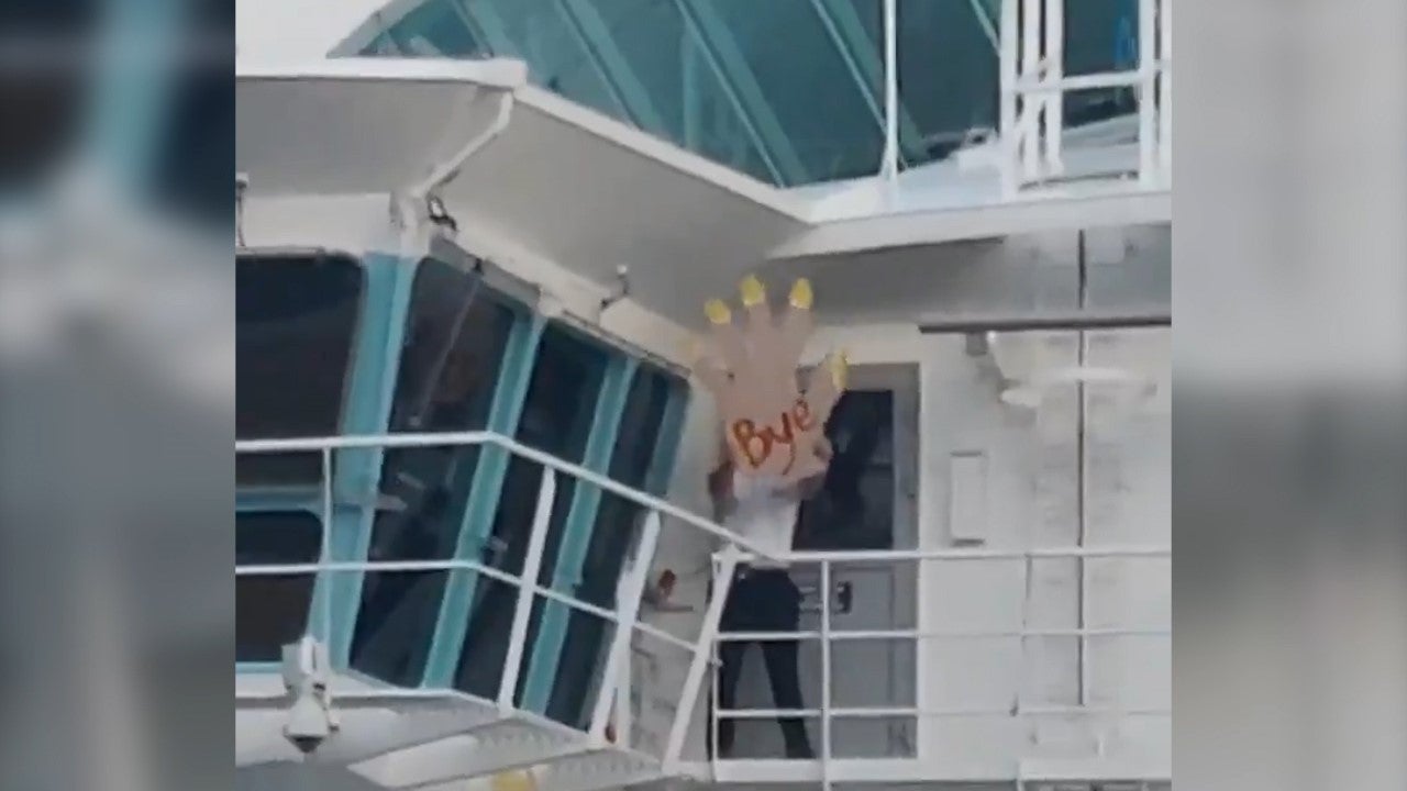 'Absolutely savage' crewman waves with giant foam hand as cruise ship leaves stranded passengers behind
