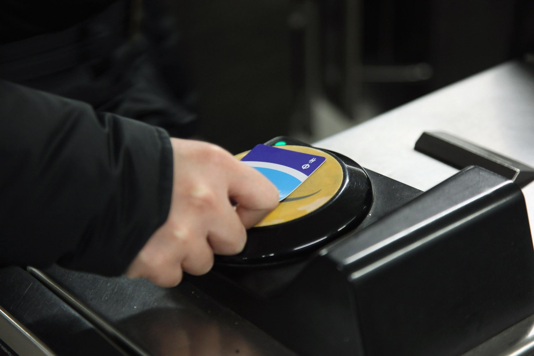 A commuter swipes his Oyster card at a London Underground station