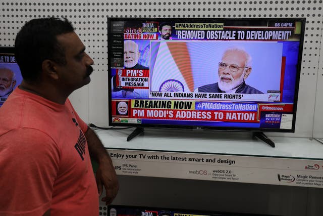 People in India watch prime minister Narendra Modi's televised address to the nation, in which he defended the decision to remove the special constitutional status granted to the disputed Kashmir region