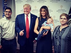 Grinning Trump gives thumbs-up with baby orphaned in El Paso shooting