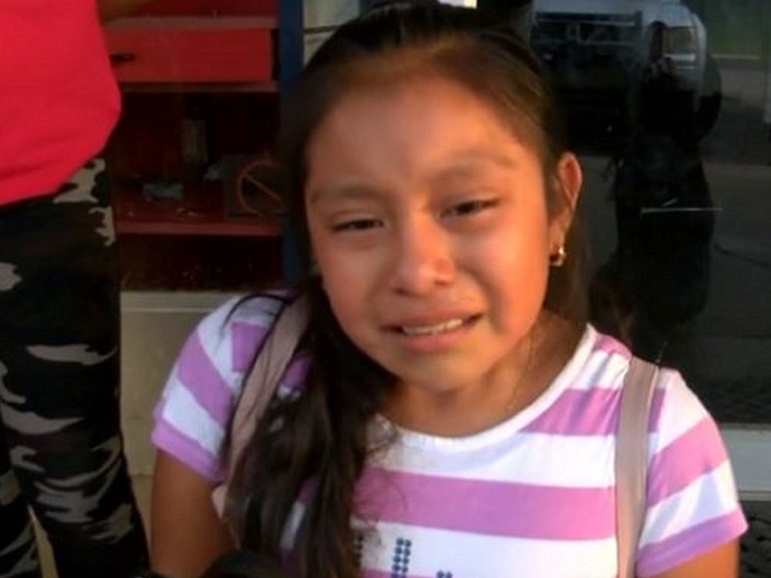 Magdalena Gomez Gregorio, 11, cries as she pleads for her father to be released following migrant raids on food factories in Mississippi, US.