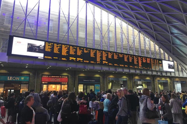 People waiting for trains at King's Cross station, London, after all services in and out of the station were suspended on Friday when a power cut caused major disruption across the country.