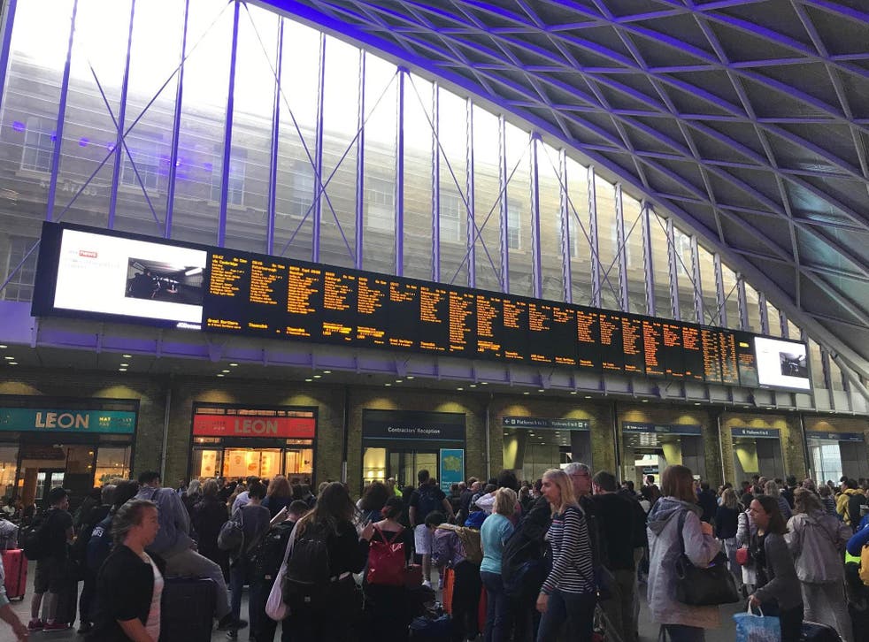 People waiting for trains at King's Cross station, London, after all services in and out of the station were suspended on Friday when a power cut caused major disruption across the country.