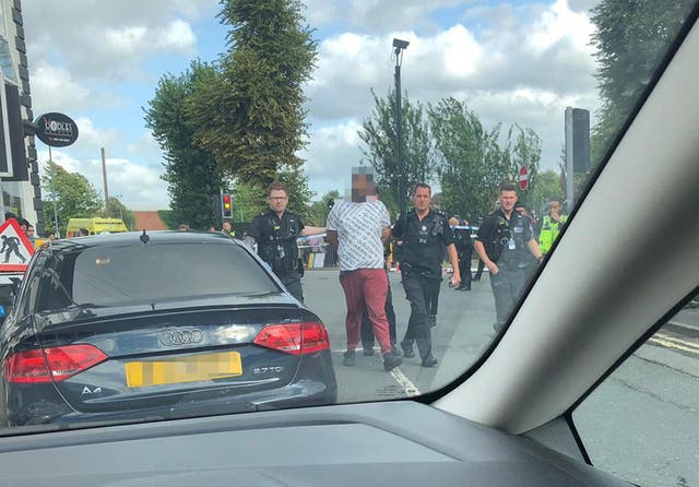 A man being detained by police after the incident, which took place on Saturday afternoon