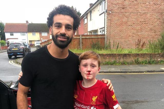 Mohamed Salah poses with young Liverpool fan