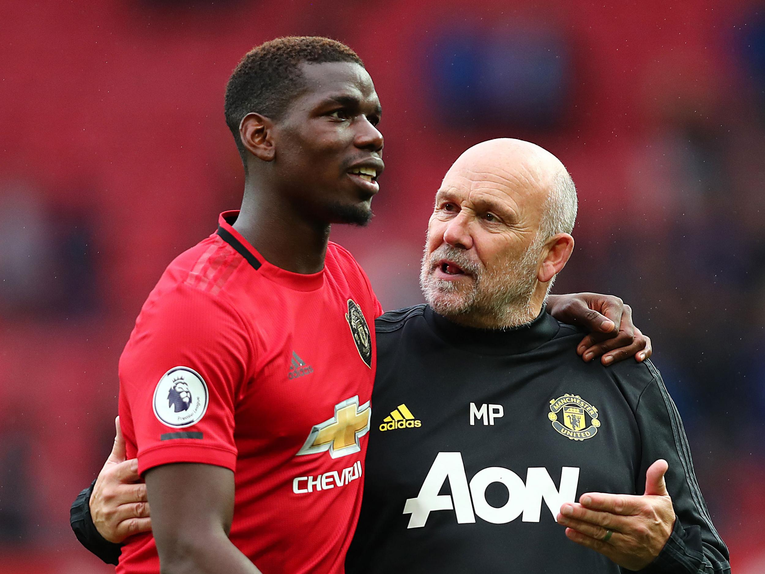 Manchester United midfielder Paul Pogba with assistant Mike Phelan (Getty)